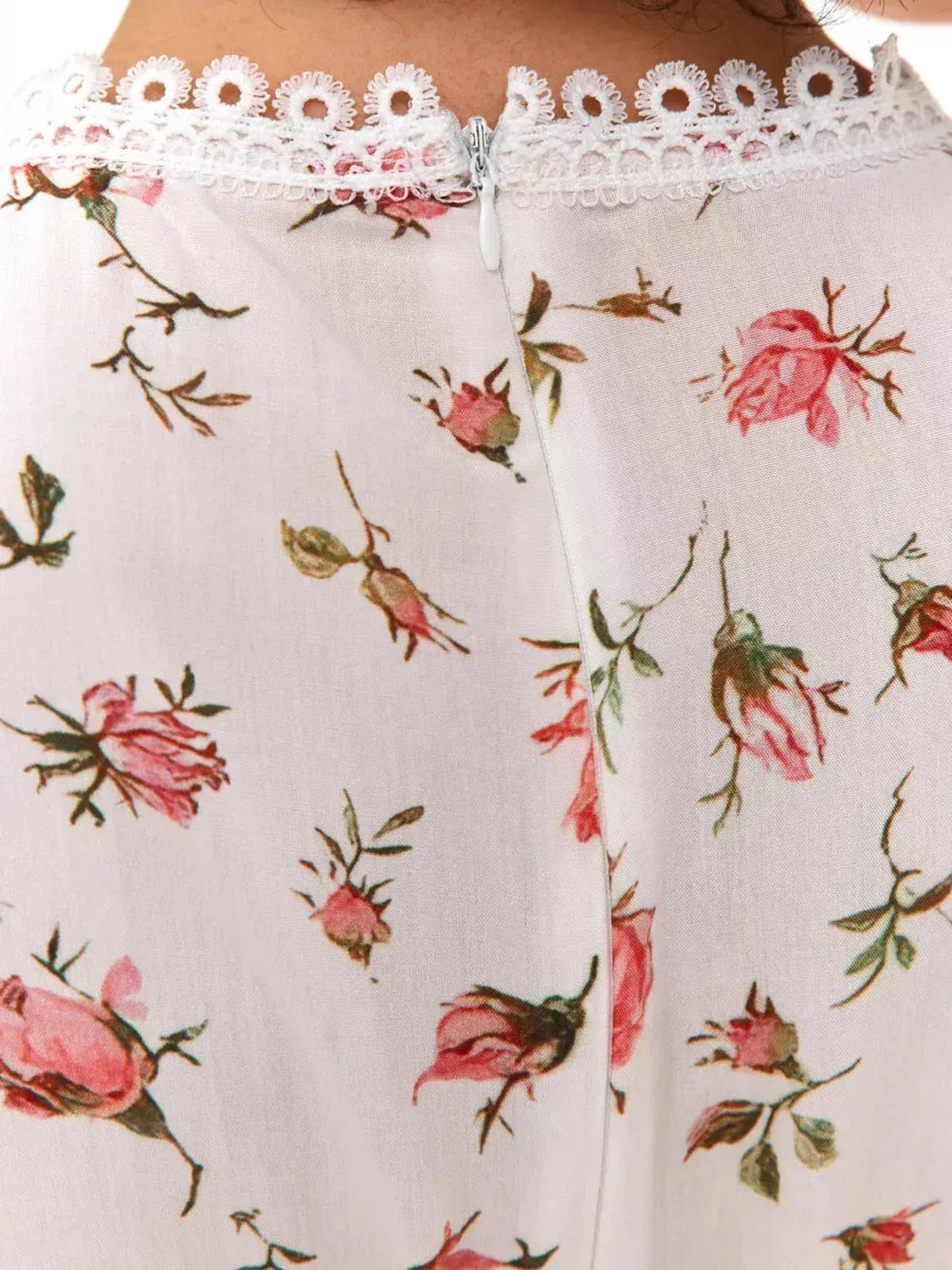 Lace trim detail on the back of the Rose Whimsy Mini Dress featuring delicate pink floral print.