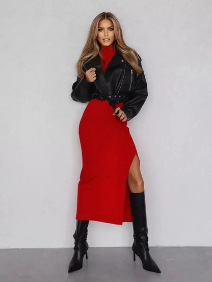 Sculpted Midi Dress in red with thigh-high slit, paired with a leather jacket and knee-high boots, ideal for formal occasions.