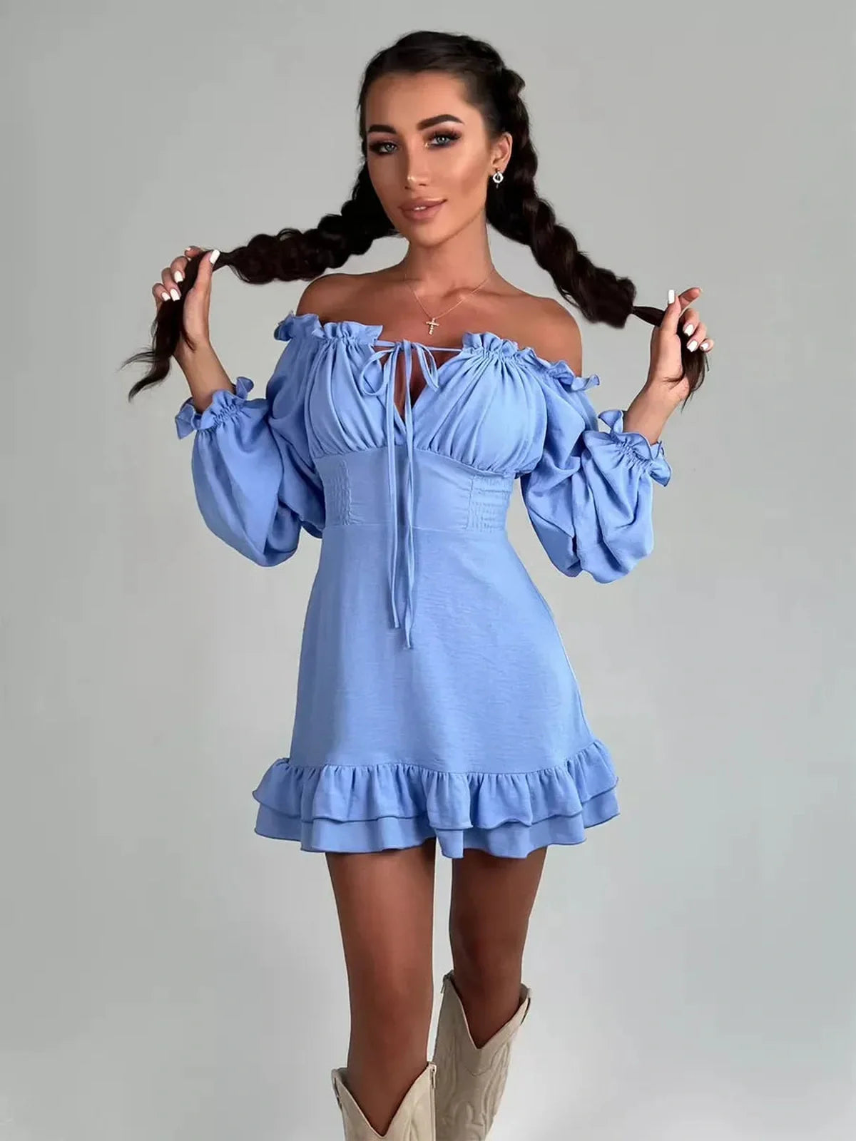 Model wearing a sky-blue Boho Frill Mini Dress with off-shoulder neckline and ruffle detail, perfect for summer occasions.