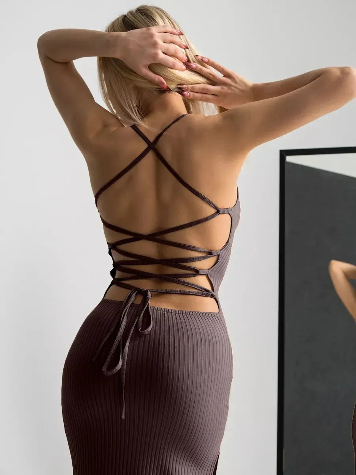 Back view of the Obsidian Midi Dress showcasing strappy lacing and a sleek silhouette, perfect for weddings and formal events.