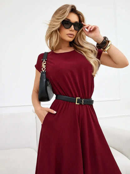 Sculpted Ease Maxi Dress in deep burgundy, featuring a cinched waist, flowing skirt, and stylish accessories.