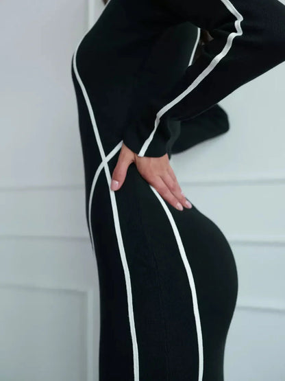 Side view of the Midnight Curve Maxi Dress featuring a sculpting silhouette with elegant white contrast piping.