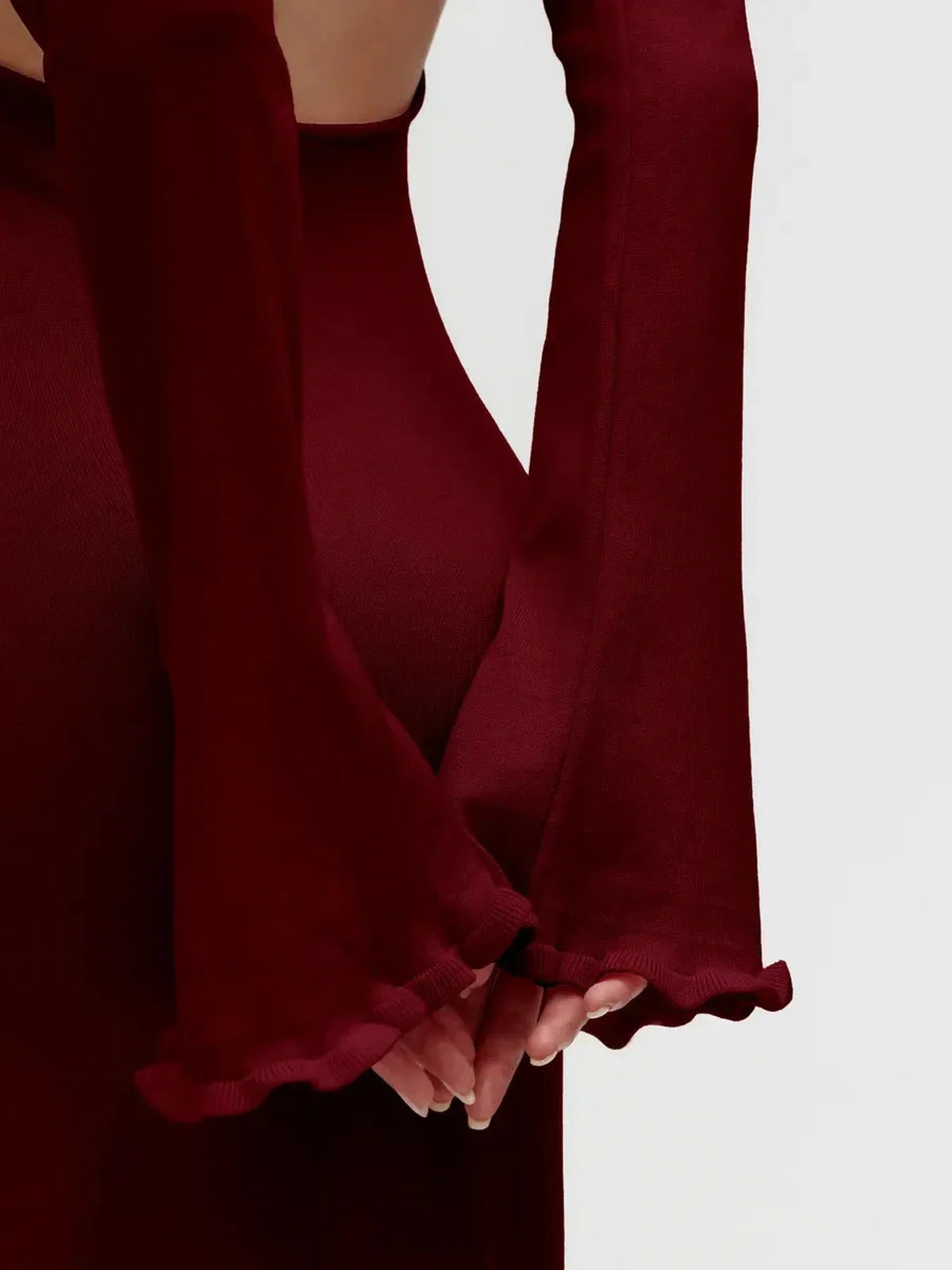 Close-up of Ruffle-Back Midi Dress showcasing elegant long sleeves and delicate ruffled trim in burgundy.