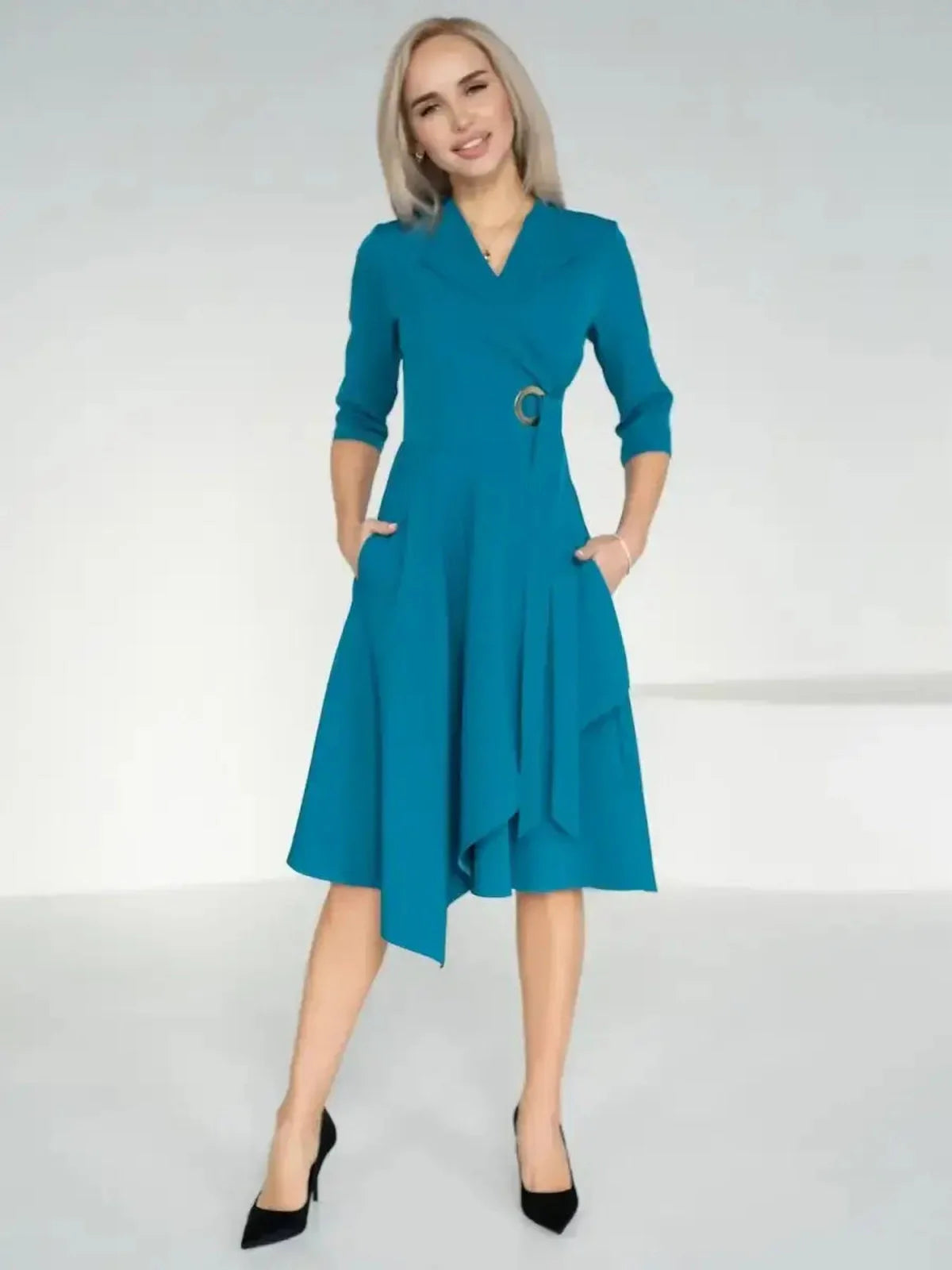 Model wearing a sea wave teal Sea Grace Midi Dress with a wrap style and A-line skirt, perfect for summer or formal events.