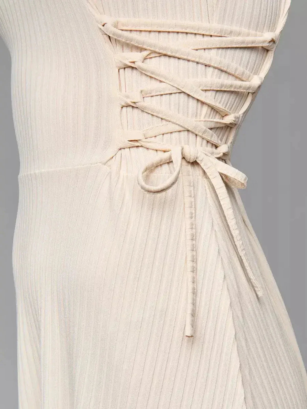 Close-up of the adjustable side lacing on the Ribbed Charm Midi Dress, showcasing refined elegance and comfort.