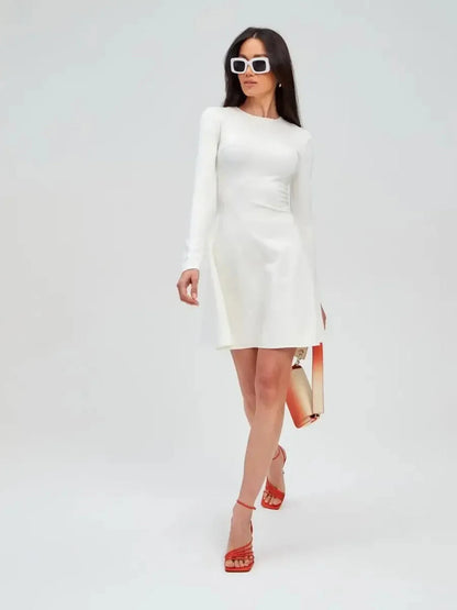 Model wearing the Ivory Sculpt Dress, a minimalist white dress, perfect for weddings and formal occasions.