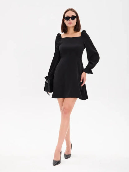 Sleek black mini dress with structured sleeves and square neckline, perfect for cocktail or wedding guest occasions.