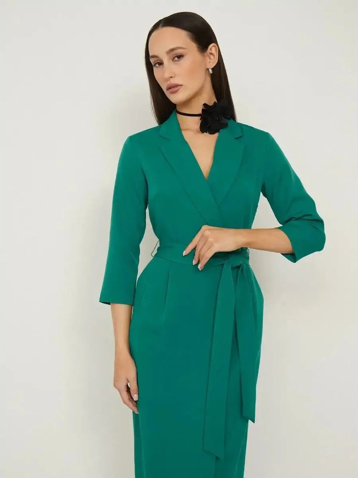 Sculpted Grace midi dress in emerald green featuring a belted waist and tailored design, ideal for formal and evening events.