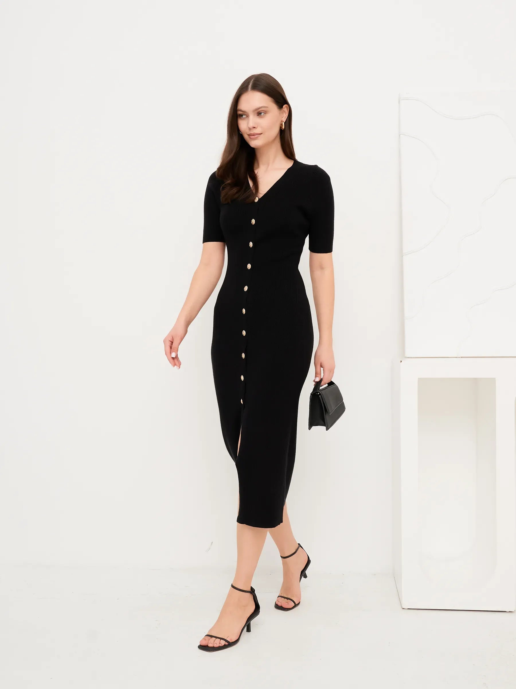 Sculpted Grace Midi Dress in black with gold button detail, stylish figure-hugging design, perfect for wedding guest or formal events.