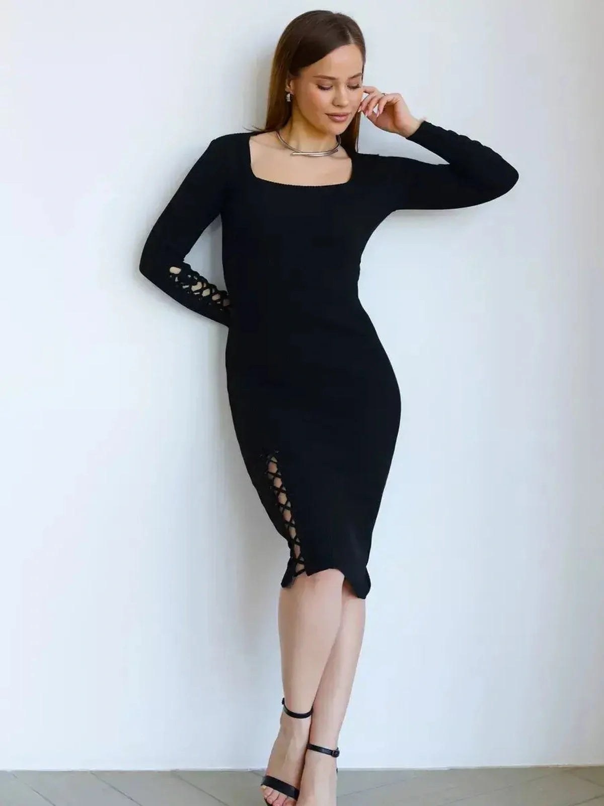 Elegant black midi dress with lace-up detailing, featuring a body-hugging fit and square neckline, perfect for special occasions.