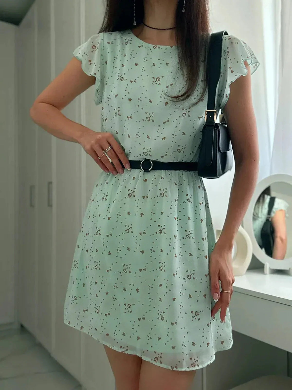 Mint Glow Mini Dress in chiffon with floral print, featuring flutter sleeves and a cinched waist, perfect for summer gatherings.