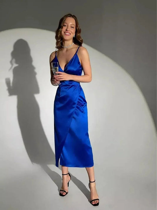 Model showcasing a Cobalt Luxe Midi Dress in satin with wrap detailing, perfect for cocktail or formal occasions.