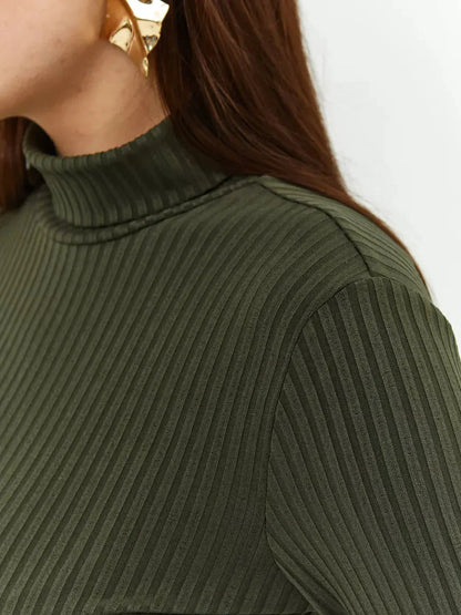 Close-up of the ribbed texture and high neckline of the Olive Curve Midi Dress in olive green.