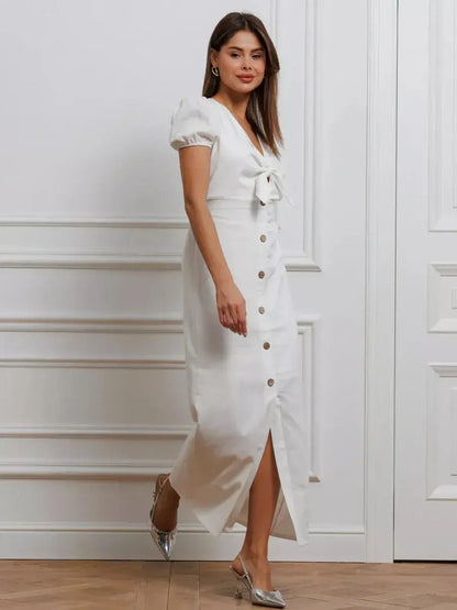 Elegant white maxi dress with puff sleeves and front tie, perfect for weddings and summer events.