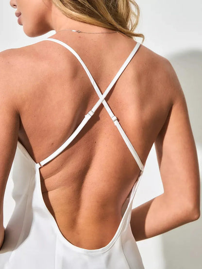 Back view of a woman in a Lustrous Charm Midi Dress, showcasing the elegant satin fabric and open-back design.