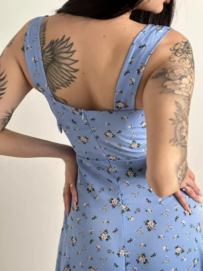 Back view of a floral midi dress with shoulder ties, showcasing a feminine design and elegant silhouette.