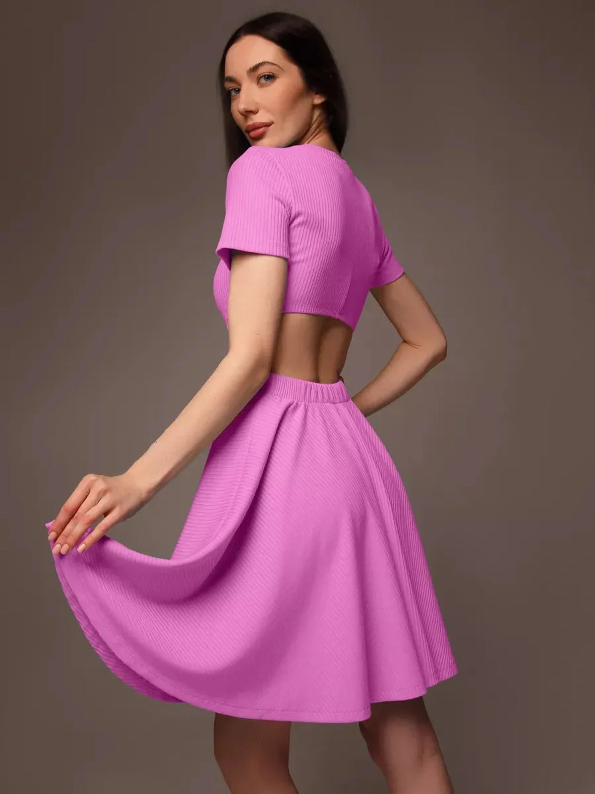Cutout Charm Mini Dress in bright pink, featuring a flared skirt and open waist detail, ideal for summer and special occasions.