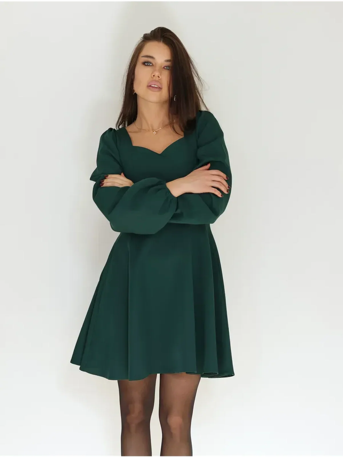 Emerald Grace mini dress features a sculpted bodice, puff sleeves, and flattering fit-and-flare silhouette.