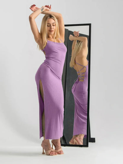 Model showcasing a lilac lace midi dress with a corset back and high side slits, perfect for weddings and special events.