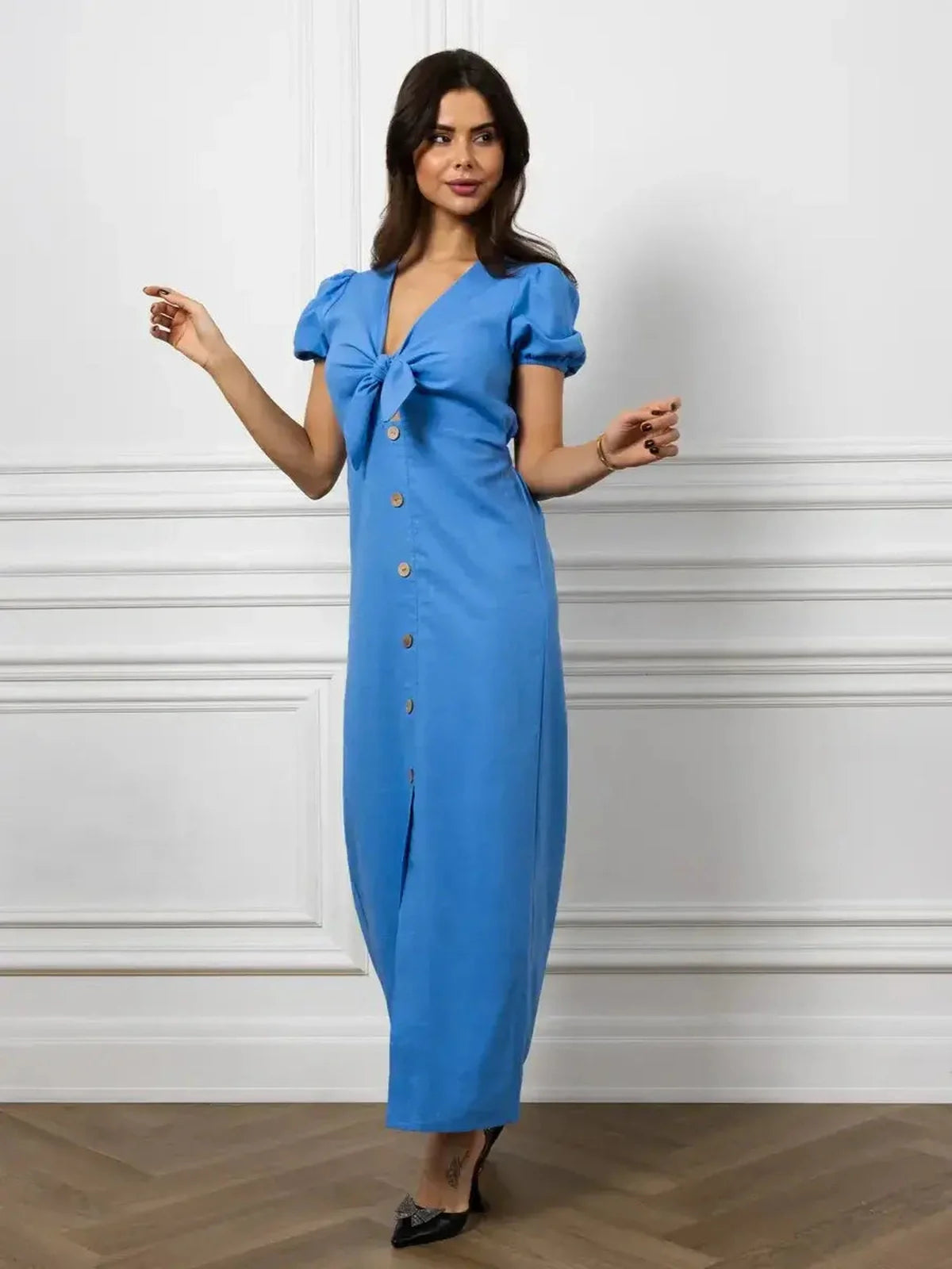 Maxi Dress Azure Charm featuring a V-neckline, waist tie, and button details, perfect for summer events and weddings.