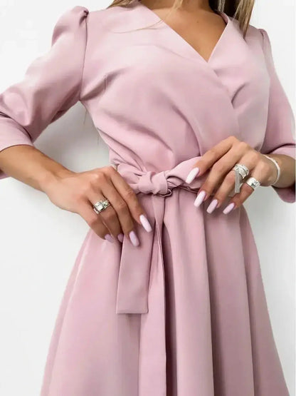 Elegant pink mini dress with a V-neckline and fitted waist, perfect for weddings and formal events.