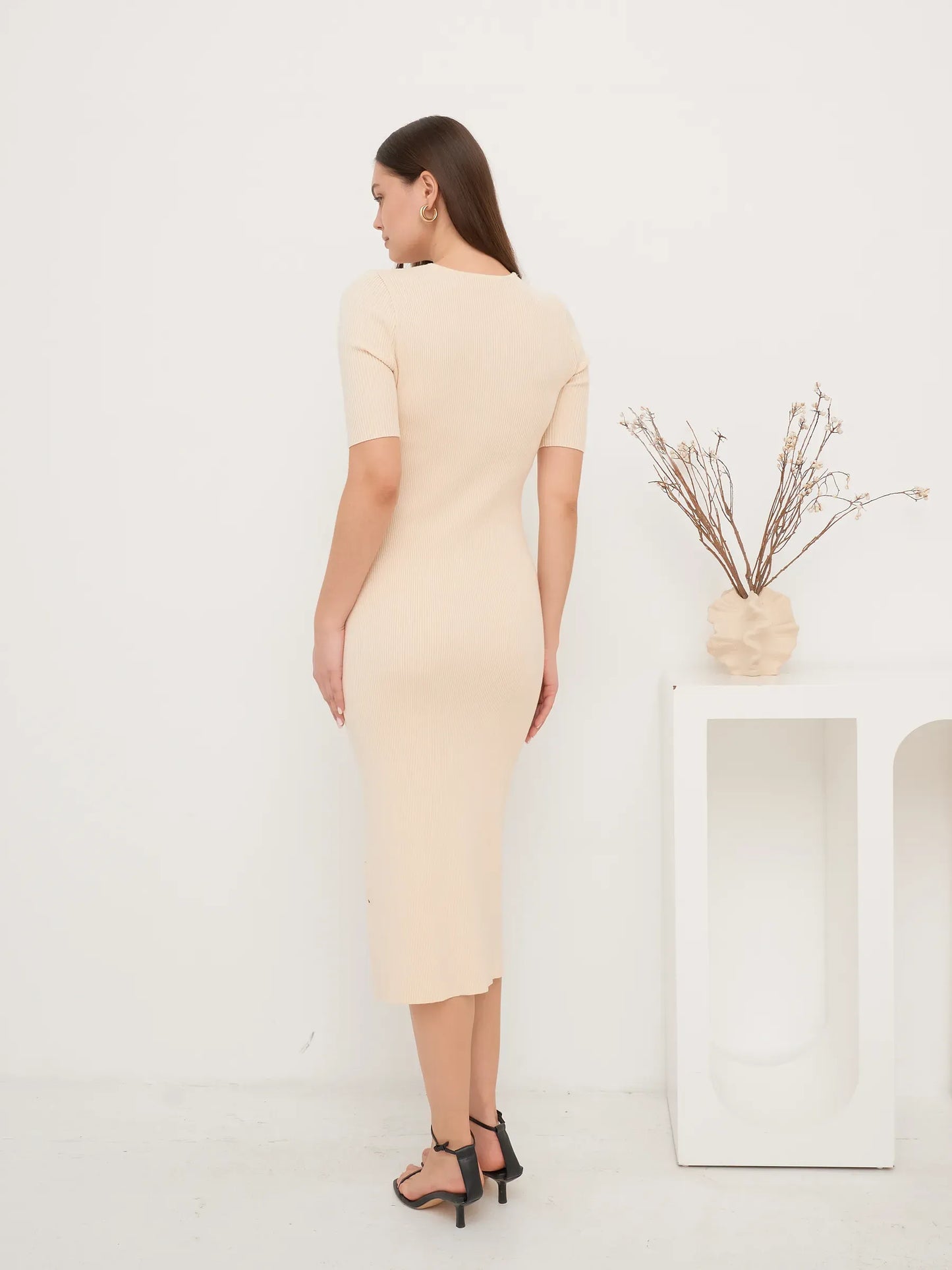 Back view of a fitted Pearl Knit Midi Dress in soft ribbed texture, ideal for wedding guest and formal occasions.