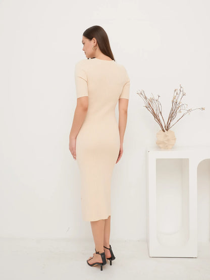 Back view of a fitted Pearl Knit Midi Dress in soft ribbed texture, ideal for wedding guest and formal occasions.
