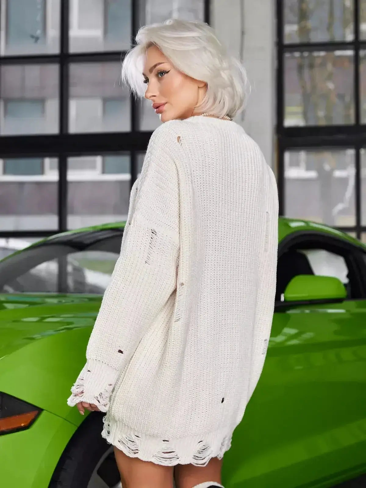 Model wearing Cloud Knit Mini dress in soft ivory with grunge texture, showcasing a relaxed fit and destroyed hem.