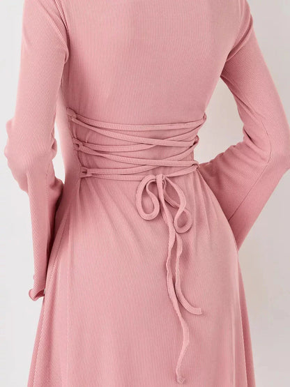 Back view of Blush Whisper pink dress featuring elegant lace-up detailing for a flattering silhouette.
