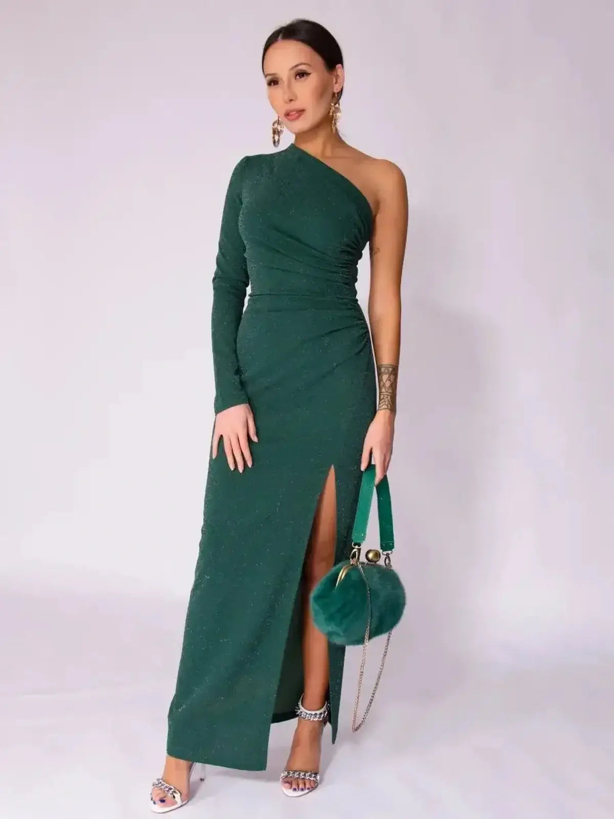 Emerald Spark Maxi Dress featuring one-shoulder design, high side slit, and shimmer for elegant summer or wedding guest attire.