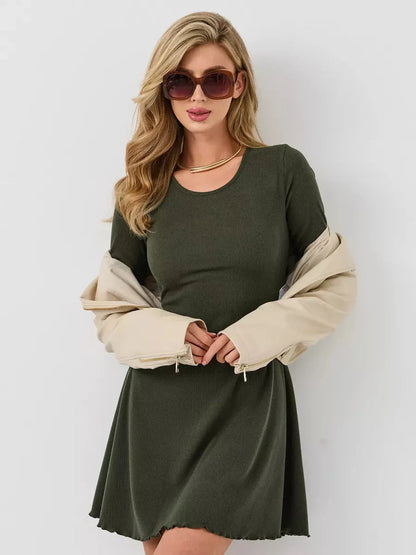 Chic olive green mini dress with long sleeves, paired with a beige jacket and trendy sunglasses.