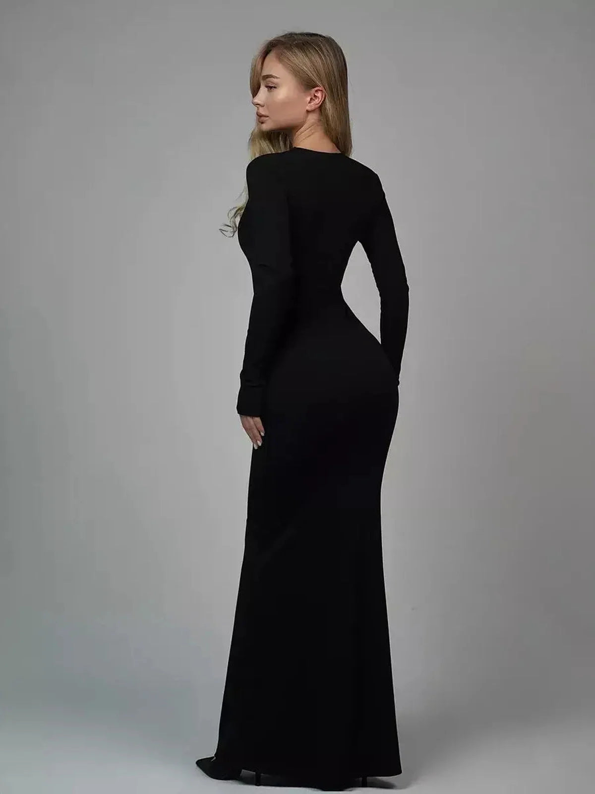 Model showcasing the Sculpted Elegance Maxi Dress in black, highlighting its sleek, curve-contouring design.