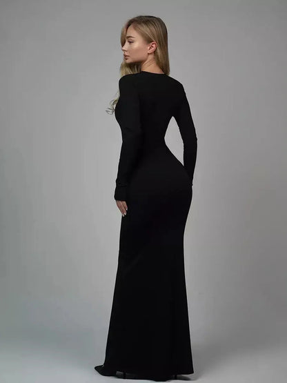 Model showcasing the Sculpted Elegance Maxi Dress in black, highlighting its sleek, curve-contouring design.