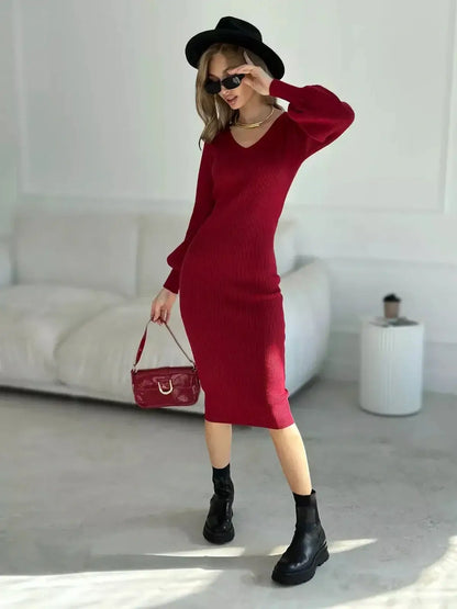 Model showcasing the Sculpted Elegance Midi Dress in rich red, featuring ribbed knit and a flattering silhouette.