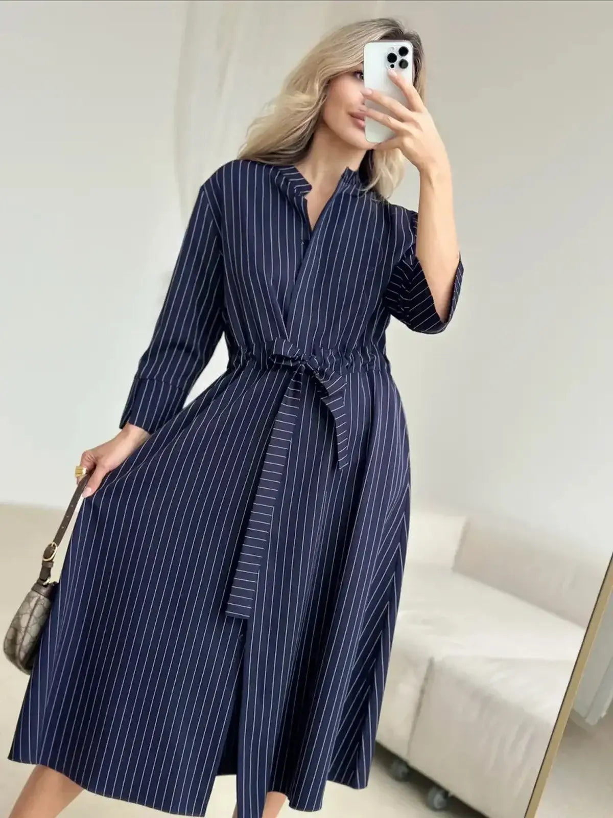 Pinstripe midi dress with relaxed fit and self-tie waist, perfect for summer, cocktail, and wedding guest occasions.
