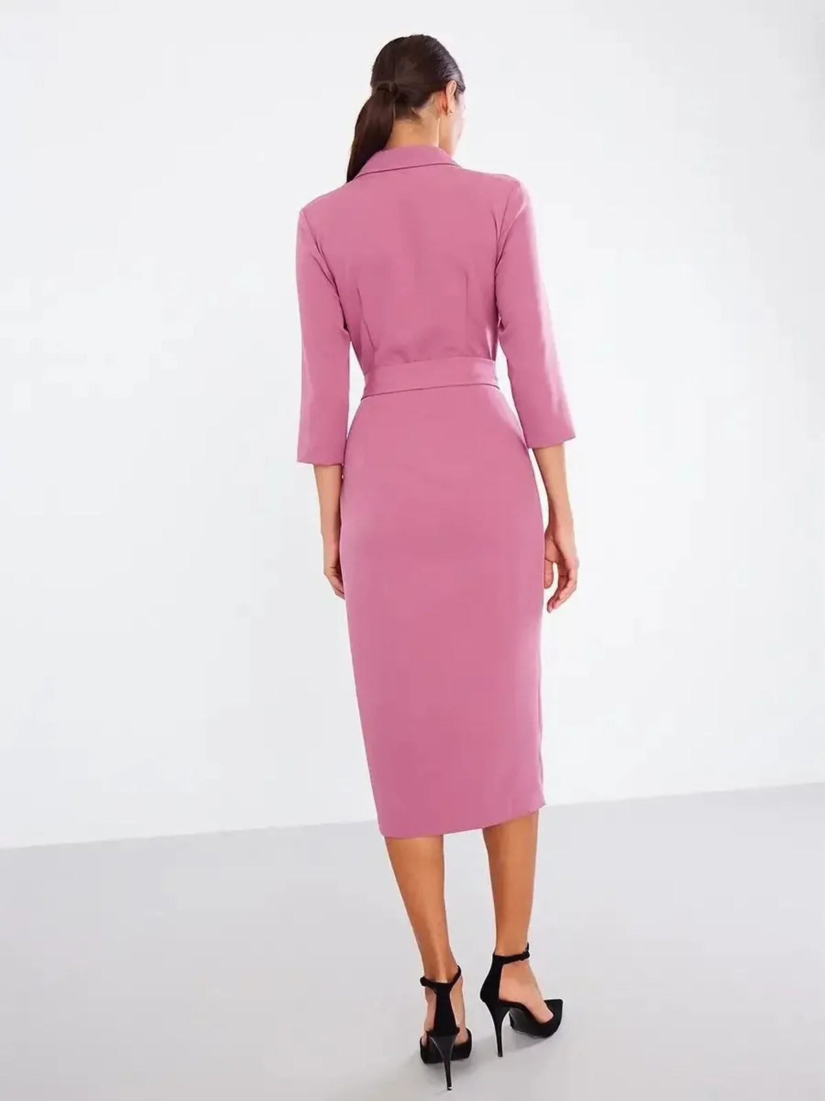Back view of a blush wrap midi dress featuring a belted waist and three-quarter sleeves, perfect for formal occasions.