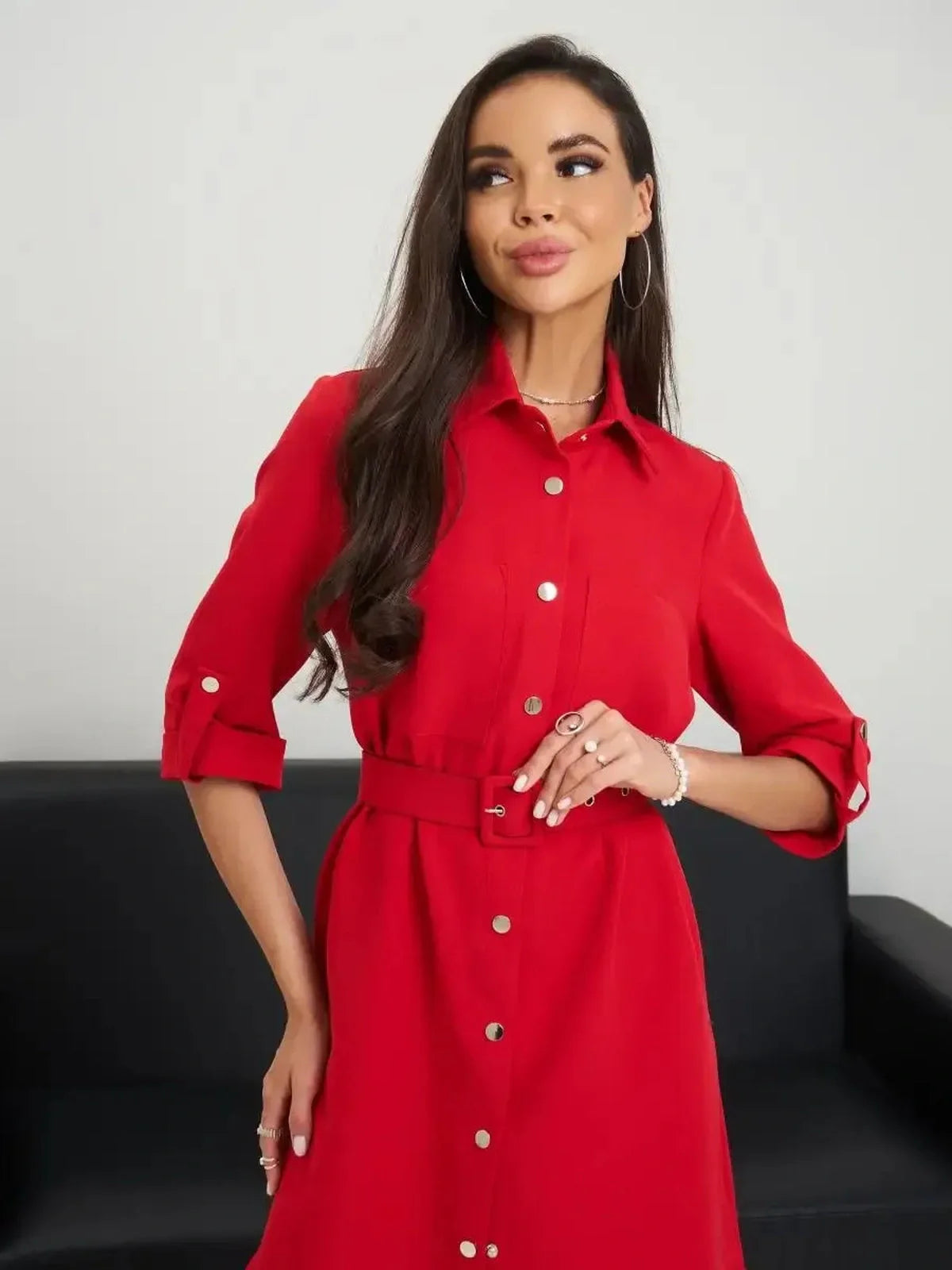Model in a red belted mini dress, showcasing a sculpted fit and stylish shirt-dress design, perfect for any occasion.