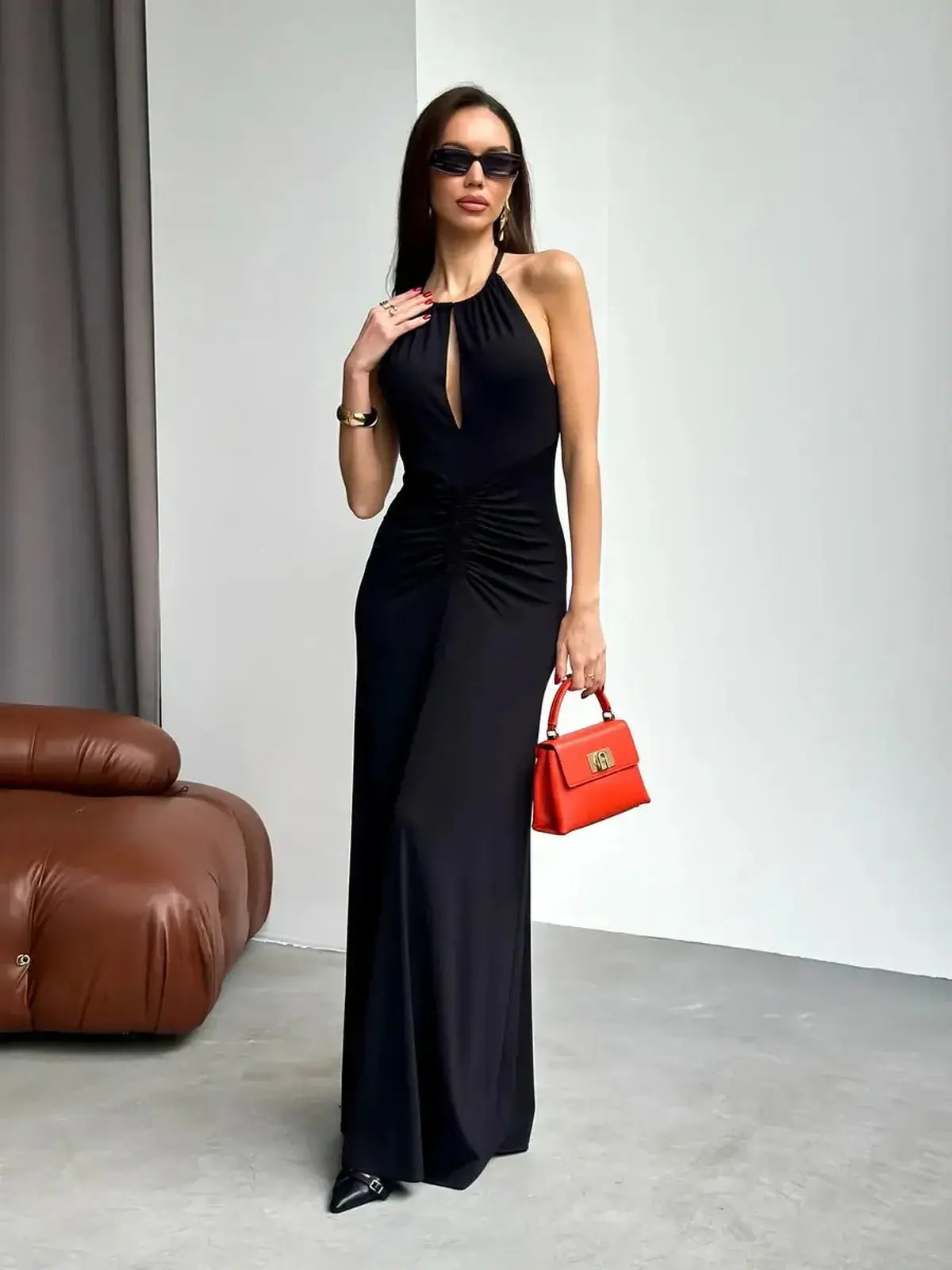 Elegant black maxi dress with halter neckline and draped detail, perfect for weddings, proms, and formal events.