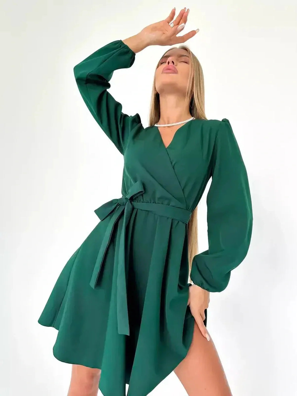 Emerald Charm mini dress featuring a flattering wrap-style bodice and V-neckline, ideal for summer and formal occasions.