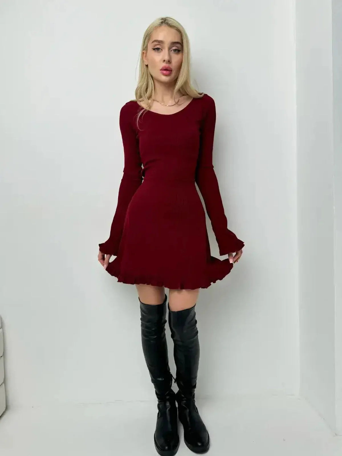 Stylish woman in a crimson red mini dress with flared sleeves, perfect for cocktail, prom, or homecoming events.