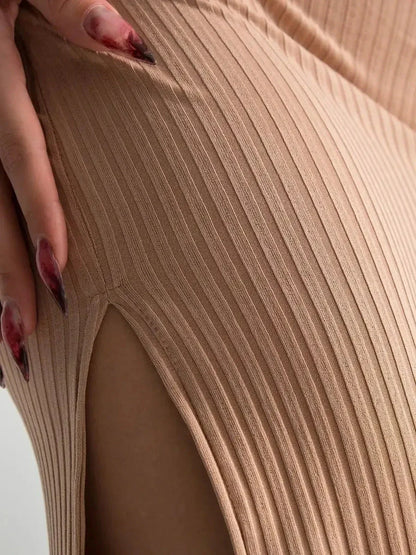 Close-up of nude lace midi dress showcasing ribbed texture and thigh-high slit detail, perfect for summer or formal occasions.