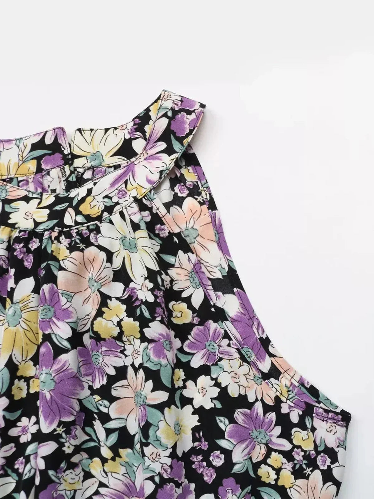 Close-up of the floral halter neckline of the Botanic Bloom Midi Dress in lightweight fabric.