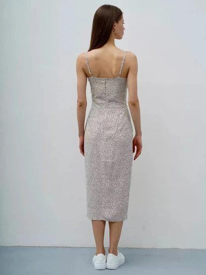 Back view of a woman in a Dot Whisper Midi Dress with playful print, perfect for summer weddings and casual occasions.