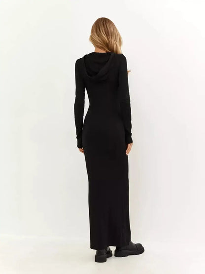 Back view of the Noir Maxi Dress featuring a hood, long sleeves, and a sleek, floor-length silhouette.