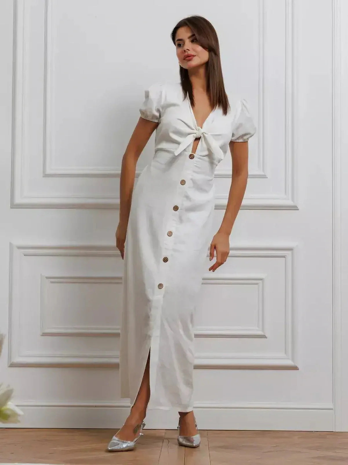 White tie-front maxi dress with puff sleeves and button-down skirt, perfect for summer weddings and formal events.