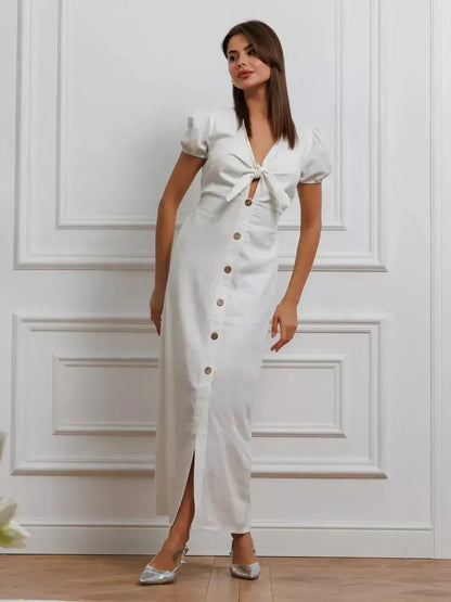 White tie-front maxi dress with puff sleeves and button-down skirt, perfect for summer weddings and formal events.