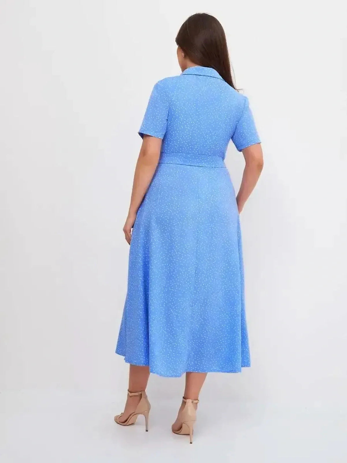 Rear view of the Skyline Dot Midi Dress in light blue with white polka dots, showcasing a flattering A-line silhouette.