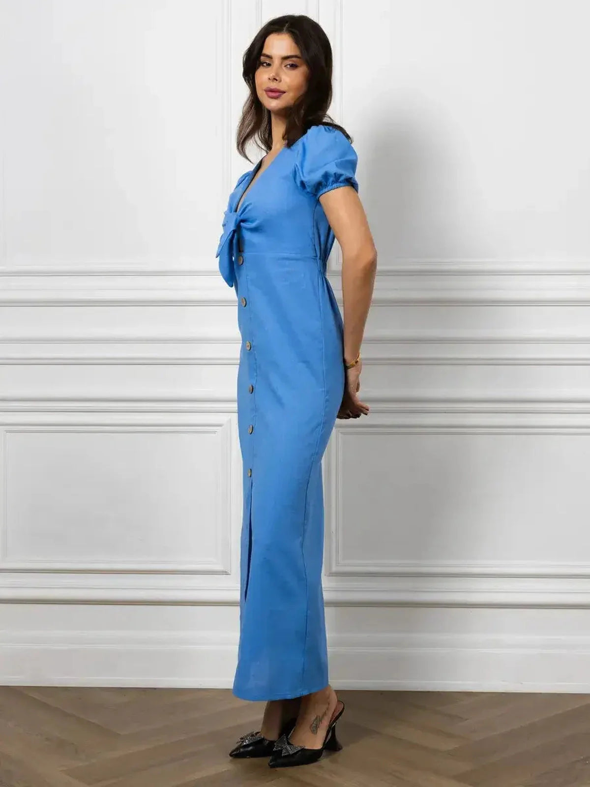 Elegant sky-blue maxi dress with V-neck, waist tie, and button details, perfect for formal events and summer occasions.