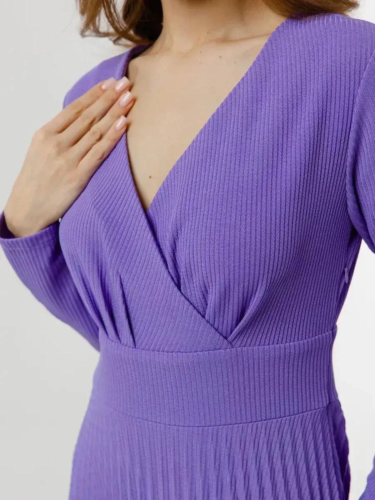 Close-up of the Luxe Pleated Midi Dress featuring a flattering V-neckline and textured fabric in rich violet.