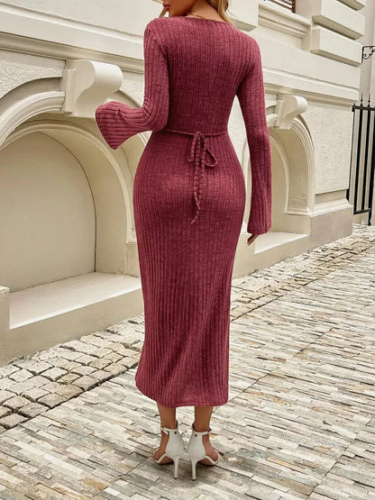 Back view of a woman in a chestnut ribbed midi dress with flared sleeves and a tie-back, ideal for elegant occasions.